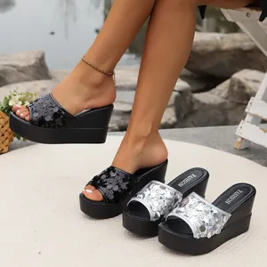 Detailed view showing sequined wedge sandals in black and silver with stylish platform soles