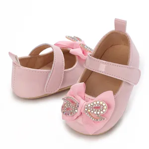 Detailed view of pink baby girl princess shoes with rhinestone bowknot