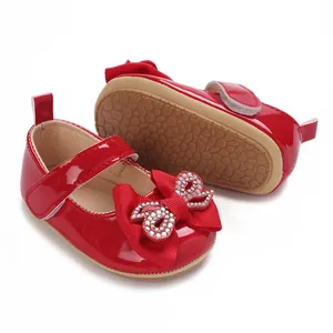 Shiny red patent leather baby girl walking shoes with sparkling rhinestone bow detail