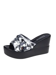 Detailed side view of silver sequined wedge platform sandal with sparkling finish.