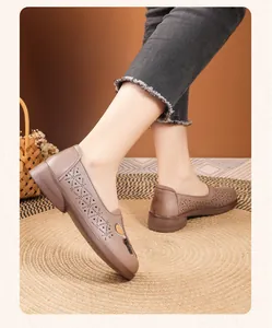 Close-up view of brown perforated flat leather shoes for middle-aged women on a model