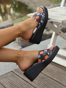 Stylish women's platform wedge slides with festive Halloween pumpkin and skull pattern