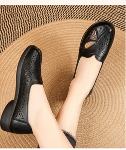 Close-up detail of breathable laser-cut patterns and butterfly embroidery on leather shoes