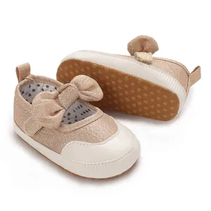 Soft-sole gold glitter baby walking shoes featuring cute bow and non-slip rubber dots
