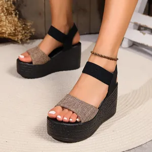 Detailed view of women's platform wedge sandals with woven texture and ankle strap