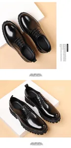 Detailed view of black genuine leather dress shoes with thick soles and round toe.