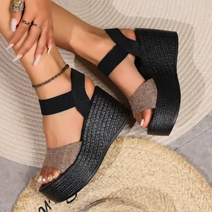 Close-up view of stylish black wedge platform sandals featuring a rustic woven texture