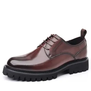 High-quality men's brown leather dress shoes featuring a thick black lug sole and round toe