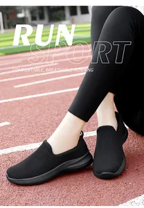 Detail of breathable black fly-knit slip-on sneakers for women on running track