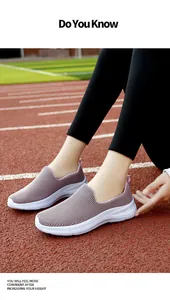 Close-up of women's breathable mesh slip-on shoes on a red track, height increasing sole.