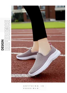Side view of women's breathable purple knit slip-on sneakers on a running track
