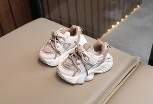 Detailed close-up view of breathable mesh toddler sneakers in beige and khaki finish
