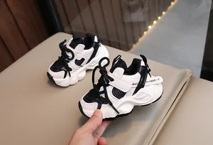 Close-up of stylish black and white breathable mesh sneakers for kids with chunky anti-slip soles