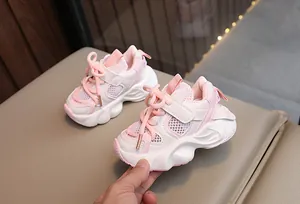 Macro view of pink breathable mesh toddler sneakers designed for casual summer wear