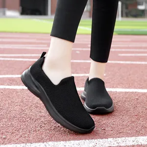 Breathable black mesh slip-on sneakers for women shown on a professional running track