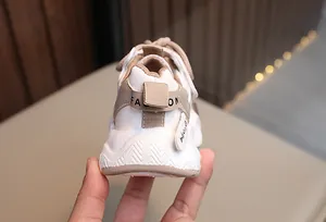 Detailed close-up of children's breathable sneaker heel with fashion strap in beige