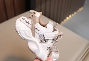 Macro view of breathable mesh toddler sneakers featuring a thick white wavy sole design