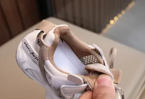 Macro detail view showing the breathable large-hole mesh lining of kids sneakers.