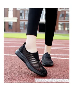 Close-up of black breathable mesh slip-on sneakers for women on a running track