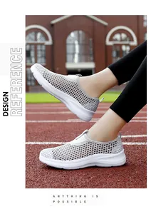Detailed view of women's breathable mesh slip-on walking shoes on a red running track