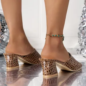 Detailed view of women's brown snake-patterned block heel mules with elegant turquoise anklet