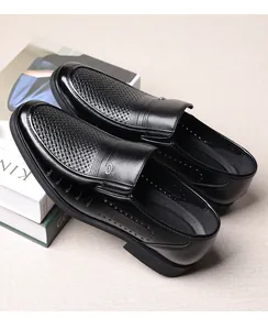 Detailed view of black breathable men's leather loafers with elegant woven pattern