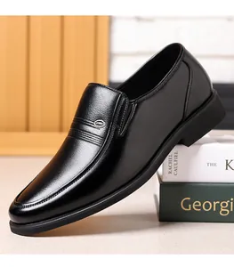 Detailed side view of elegant black leather loafers for men on decorative book props