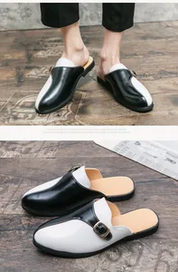 Gros plan sur des mules en cuir bicolores noir et blanc pour homme avec boucle stylée