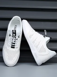 Detailed view of men's white leather sneakers with breathable perforated patterns