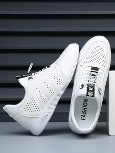 Close-up of white perforated leather elevator sneakers with casual sports design