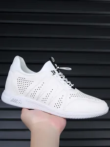 Close-up of white perforated leather men's sneakers featuring a hidden height increase.