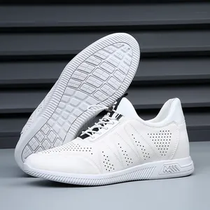 Detail view of men's white leather sneakers with perforated design and elastic laces