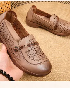 Close-up detail of breathable perforated tan soft sole loafers for elderly women