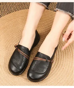 Detailed view of black breathable hollow-out leather loafers for elderly women