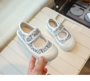 Close-up detail of girls' silver sequin princess shoes featuring a secure velcro strap