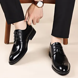 Classic black men's business dress leather shoes with brogue detailing and soft sole