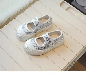 Close-up of girls' silver sequin canvas shoes with hook and loop strap