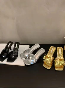 Detail view of French style sequin mule high heel sandals in black, silver, and gold.