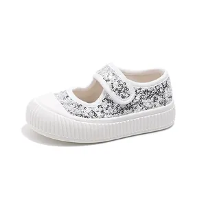 Fashionable girl's white canvas shoes with silver sequins and velcro strap closure