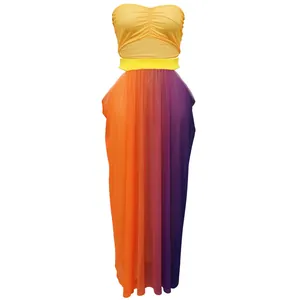 Detail of two-piece beach set with yellow tube top and gradient maxi skirt.
