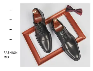 Elegant top view of black leather cap-toe Oxford dress shoes for men with wooden shoe trees