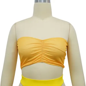 Close-up detail of a bright yellow ruched bandeau top displayed on a studio mannequin