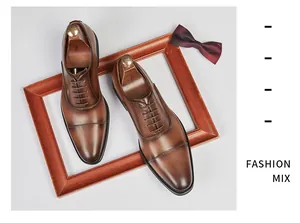 Detailed view of brown leather Oxford dress shoes featuring classic cap-toe design