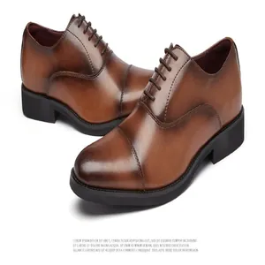 Macro view of men's brown leather oxford dress shoes with triple-toe cap detailing