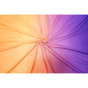 Detailed macro view of vibrant orange to purple gradient mesh fabric for beach wear.