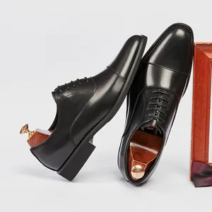 Premium black leather Oxford dress shoes for men with classic cap toe and lace-up design.