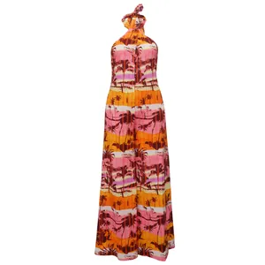 Vibrant tropical print halter backless wide-leg jumpsuit featuring palm tree sunset pattern