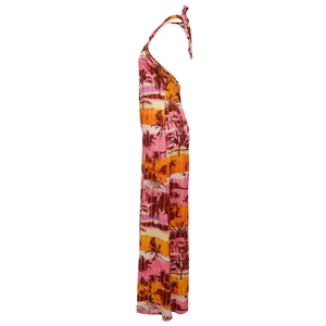 Side profile of a vibrant tropical palm print halter-neck backless jumpsuit for women