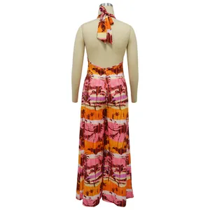 Detail view showing the backless design of a tropical print halter neck jumpsuit