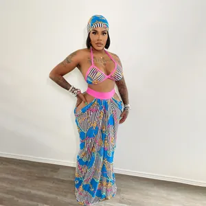 Model wearing a three-piece beach set with nautical chain print and hip cut-out skirt